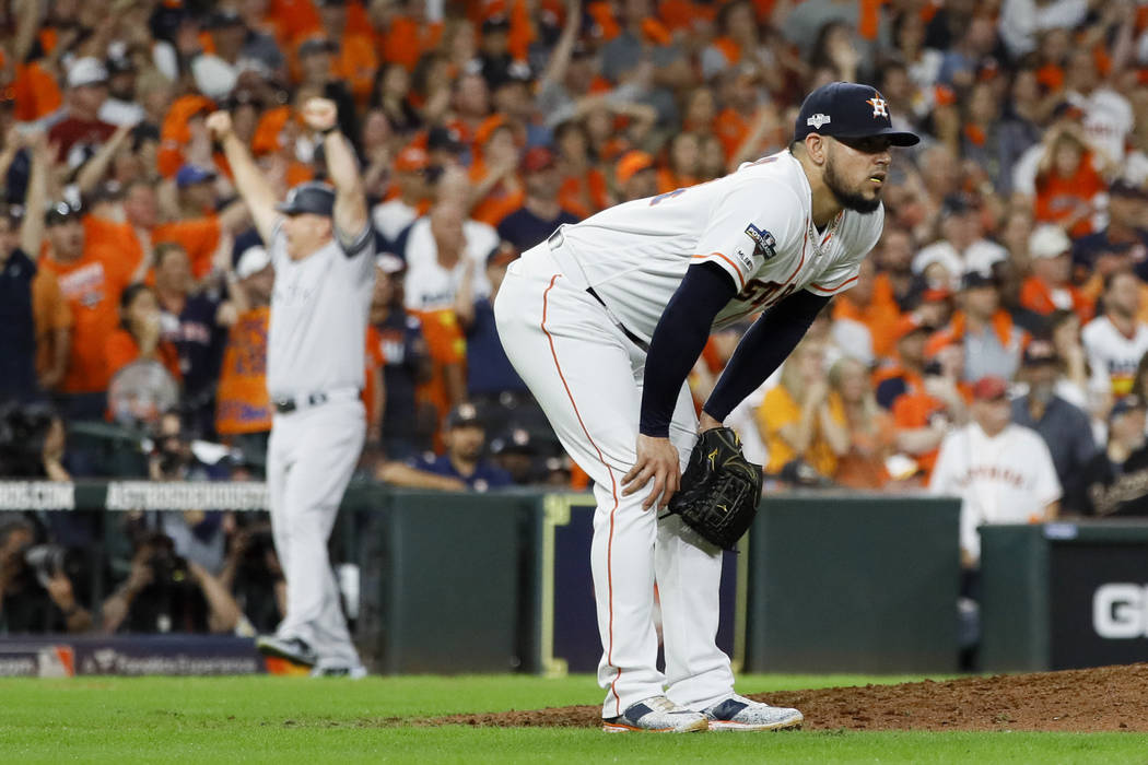 Houston Astros relief pitcher Roberto Osuna reacts after giving up a two-run home run to New Yo ...
