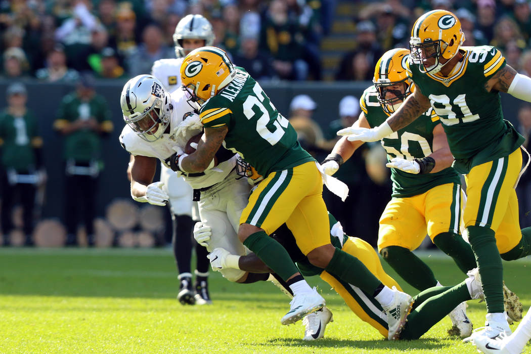 Green Bay Packers cornerback Jaire Alexander (23) tackles Oakland Raiders running back Josh Jac ...