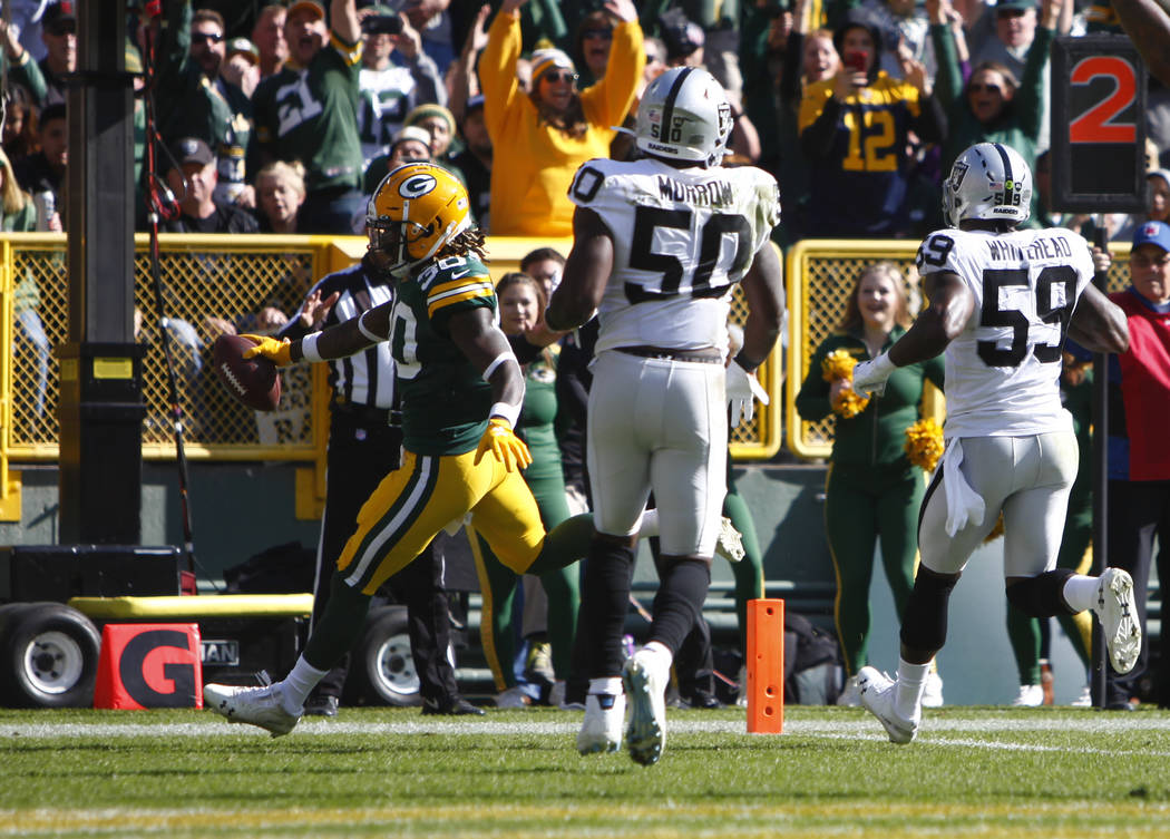 Green Bay Packers running back Jamaal Williams (30) runs in to the end zone as Oakland Raiders ...