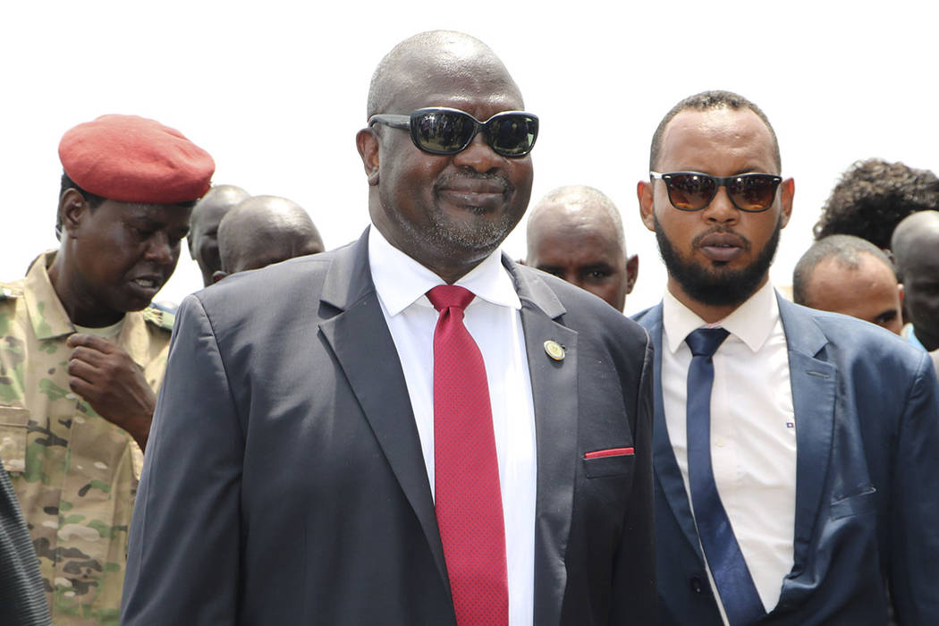 South Sudan opposition leader Riek Machar, centre, as he returns to the country, in Juba, Satur ...