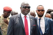 South Sudan opposition leader Riek Machar, centre, as he returns to the country, in Juba, Satur ...