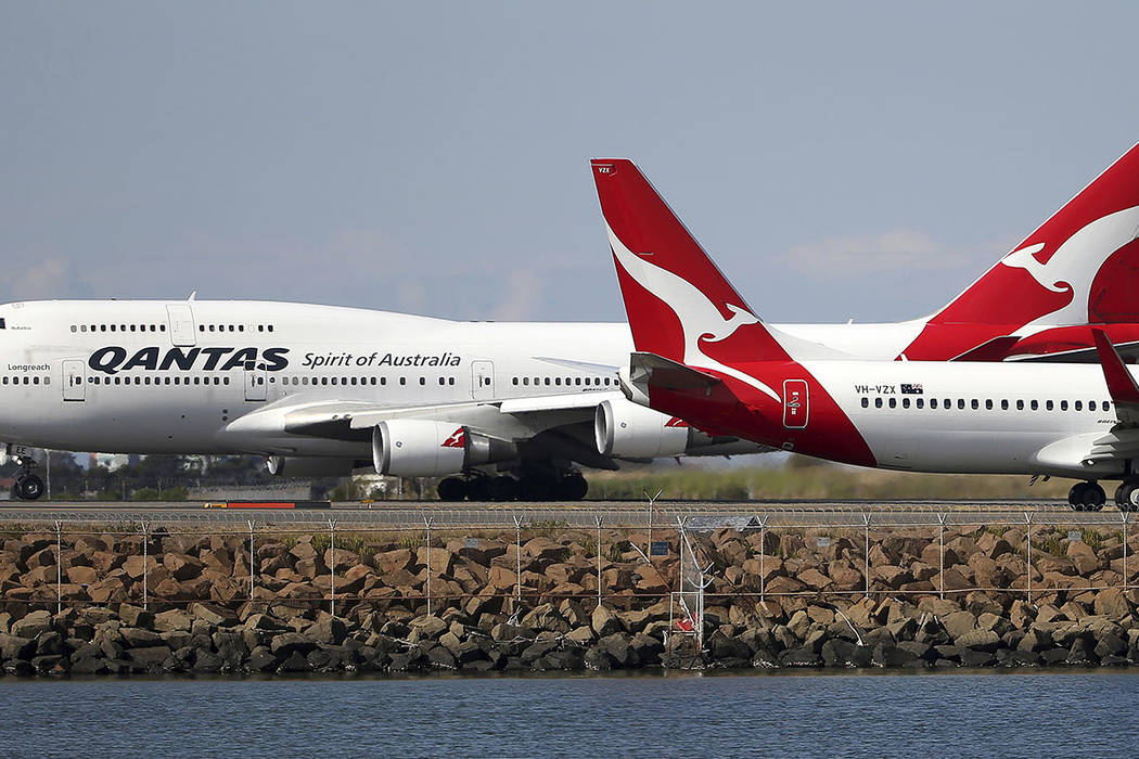 FILE - In this Aug. 20, 2015 file photo, two Qantas planes taxi on the runway at Sydney Airport ...