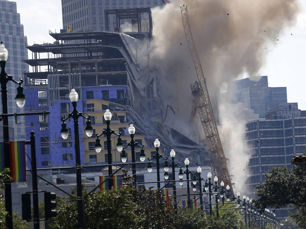 Two large cranes from the Hard Rock Hotel construction collapse come crashing down after being ...