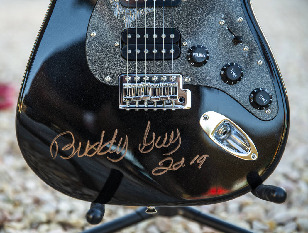 A Buddy Guy signed Squier Strat by Fender guitar awaits auctioning during the 2nd Annual Fall i ...
