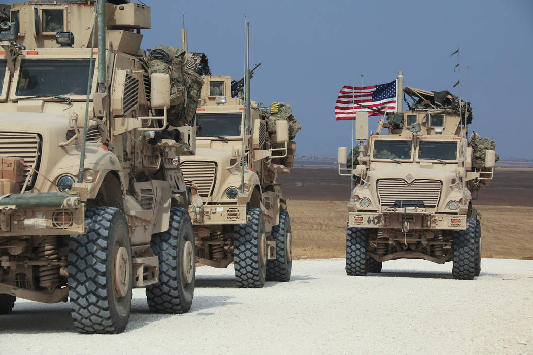 American military convoy stops near the town of Tel Tamr, north Syria, Sunday, Oct. 20, 2019. K ...