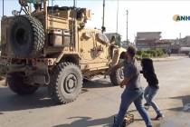 In this frame grab from video provided by Hawar News, ANHA, the Kurdish news agency, residents ...