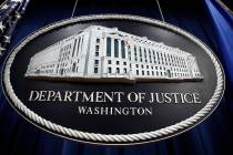 A Thursday, April 18, 2019, file photo shows a sign for the Department of Justice hangs in the ...