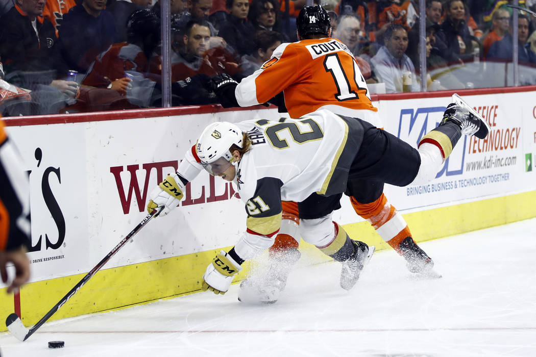 Vegas Golden Knights' Cody Eakin (21) dives for the puck past Philadelphia Flyers' Sean Couturi ...
