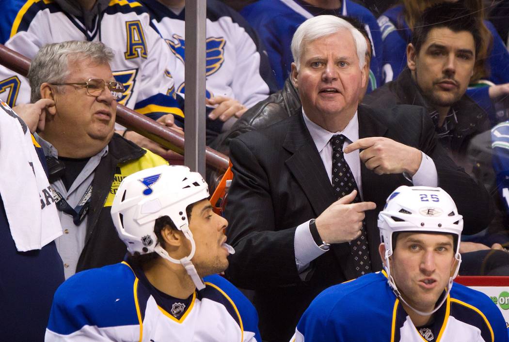 St. Louis Blues coach Ken Hitchcock gestures on the bench behind Ryan Reaves, lower left, and C ...