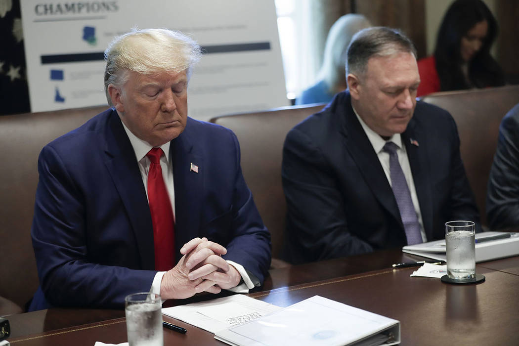 President Donald Trump, left, and Secretary of State Mike Pompeo, right, pause during an openin ...