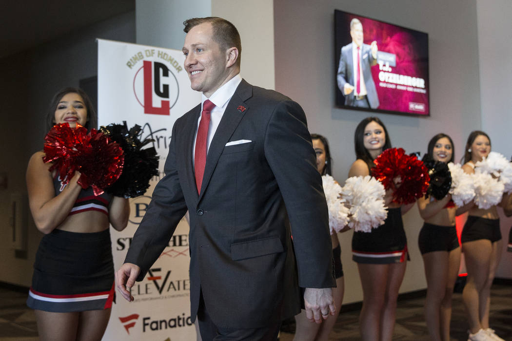 New UNLV men's basketball coach T.J. Otzelberger walks to the podium at the Strip View Pavilion ...