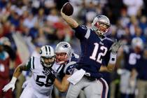 New England Patriots quarterback Tom Brady throws as New York Jets defensive end Jason Babin (5 ...