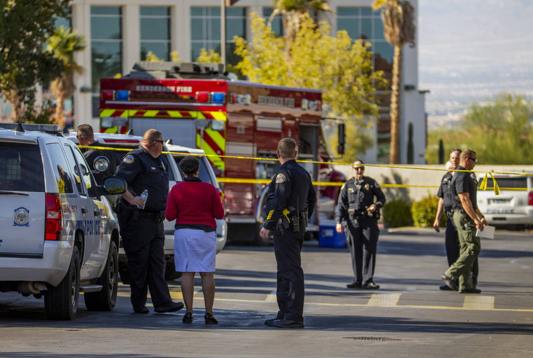 Officers work the scene of an officer-involved shooting at The Equestrian on Eastern Apartments ...