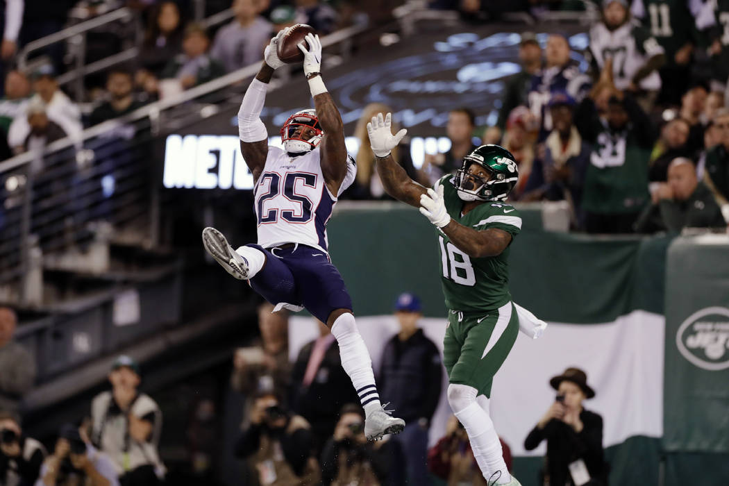 New England Patriots' Terrence Brooks (25) intercepts a pass to New York Jets' Demaryius Thomas ...