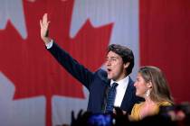 Liberal leader Justin Trudeau and wife Sophie Gregoire Trudeau wave as they go on stage at Libe ...