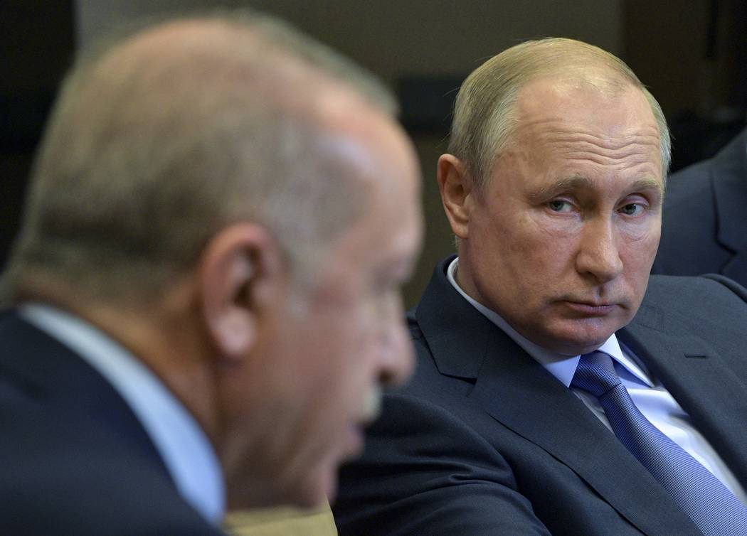 Russian President Vladimir Putin, right, listens to Turkish President Recep Tayyip Erdogan duri ...