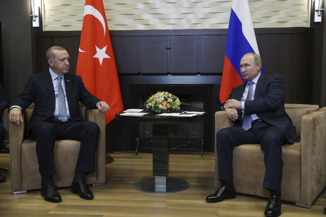 Russian President Vladimir Putin, right, and Turkish President Recep Tayyip Erdogan speak durin ...
