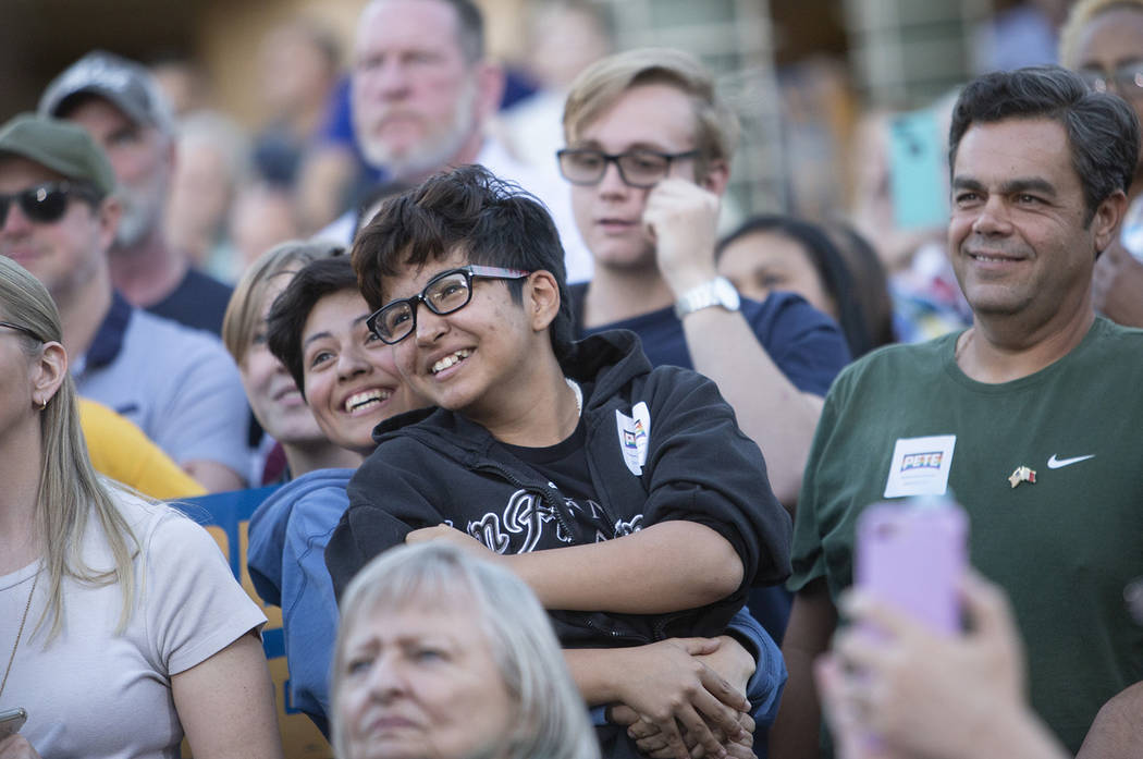 Dia Andreo, left, hugs Eli Serrato as Pete Buttigieg addresses them directly because of their y ...
