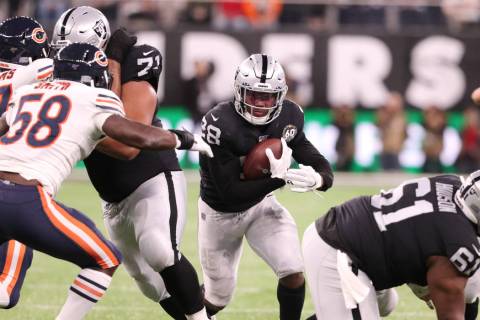 Oakland Raiders running back Josh Jacobs (28) runs with the football during the first half of a ...