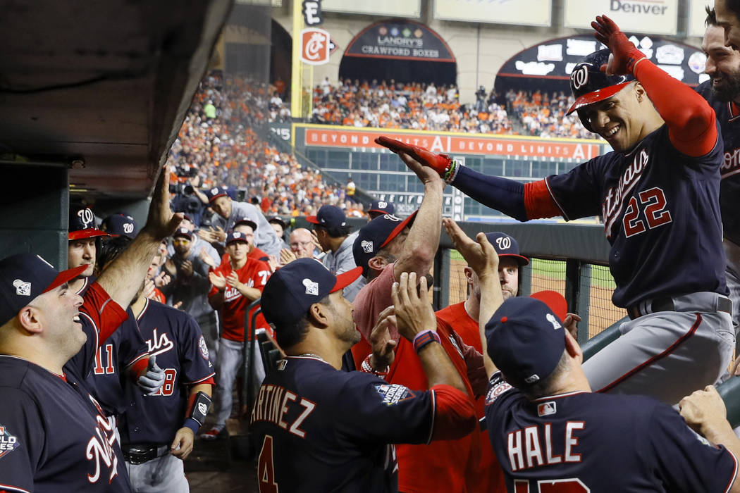 Washington Nationals' Juan Soto celebrates in the dugout after his home run against the Houston ...