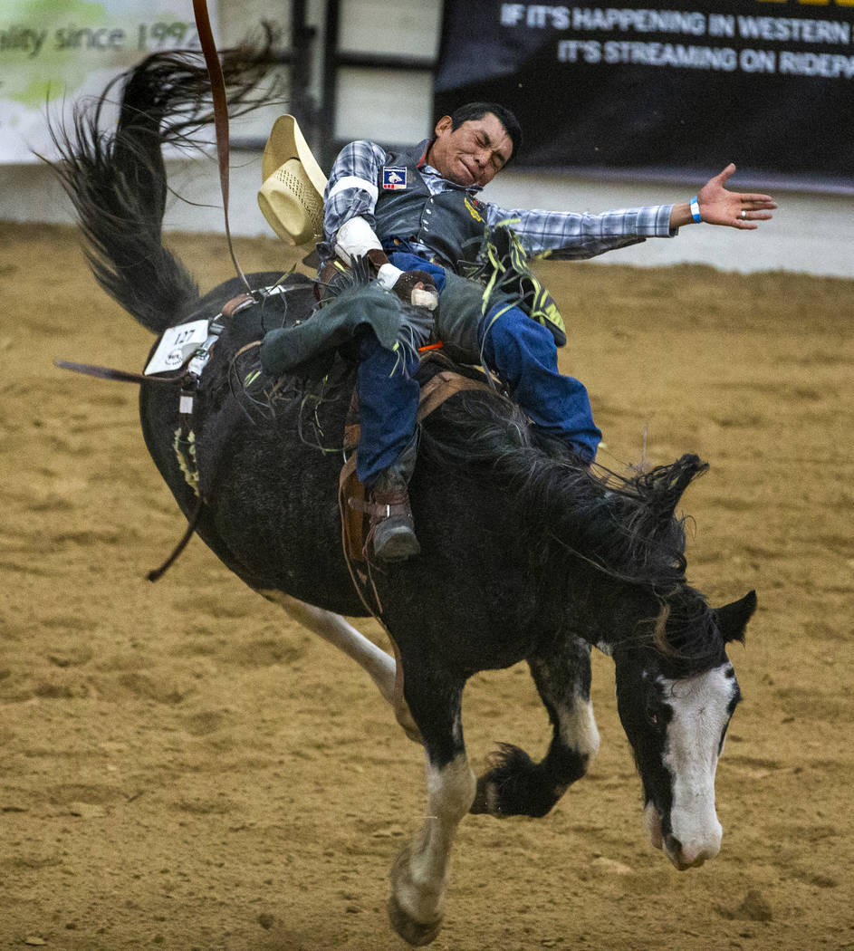 Bareback rider Tyrick Wilson hangs on tight to his horse during the first round of the Indian N ...