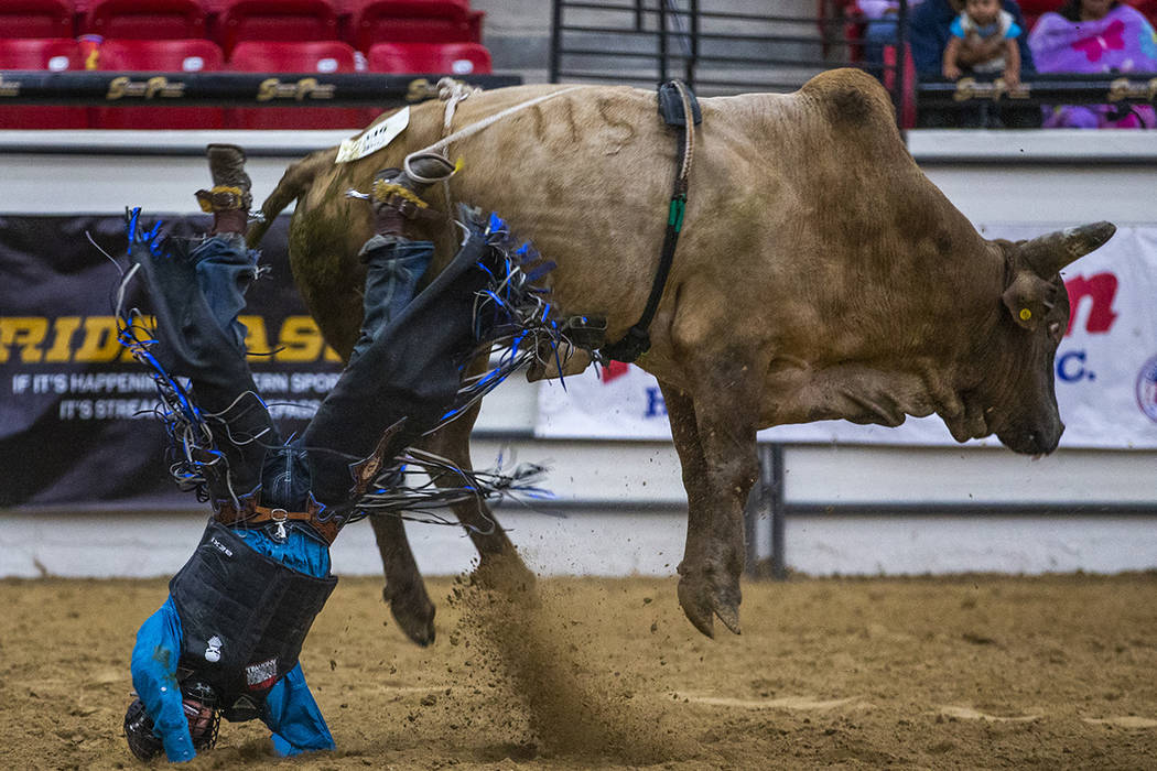 Bull rider Justin Little Plume crashes to the dirt after being thrown from his bull during the ...