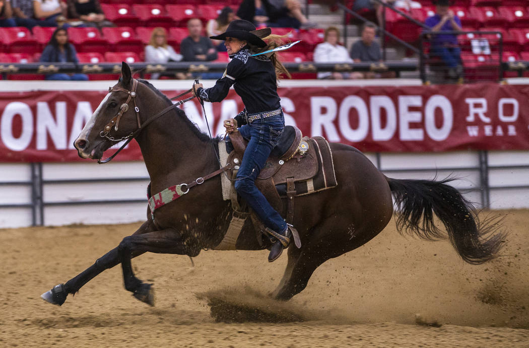 Barrel racer Sallye Williams readies to cut the barrel close with her horse during the first ro ...