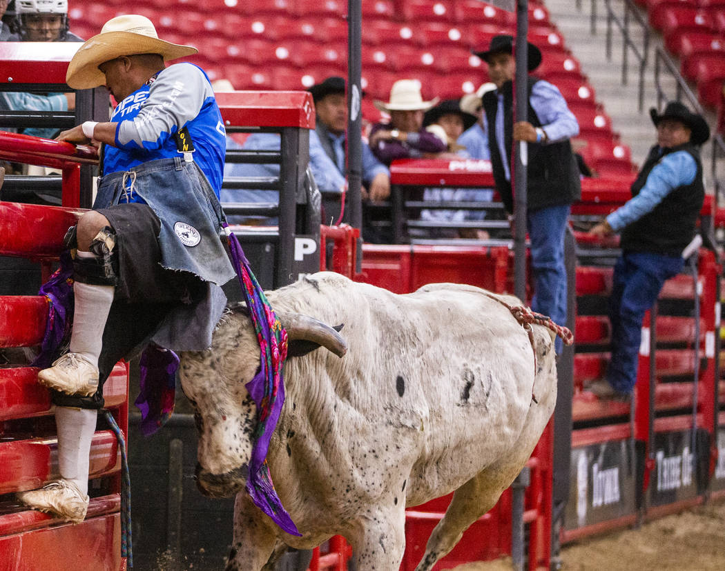A rodeo clown nearly gets the horns of a bull after the rider dismounted him during the first r ...
