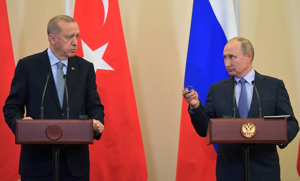 Russian President Vladimir Putin, right, and Turkish President Recep Tayyip Erdogan look at eac ...