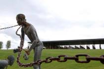 In a Sunday, April 22, 2018, file photo, a statue of a chained man is on display at the Nationa ...