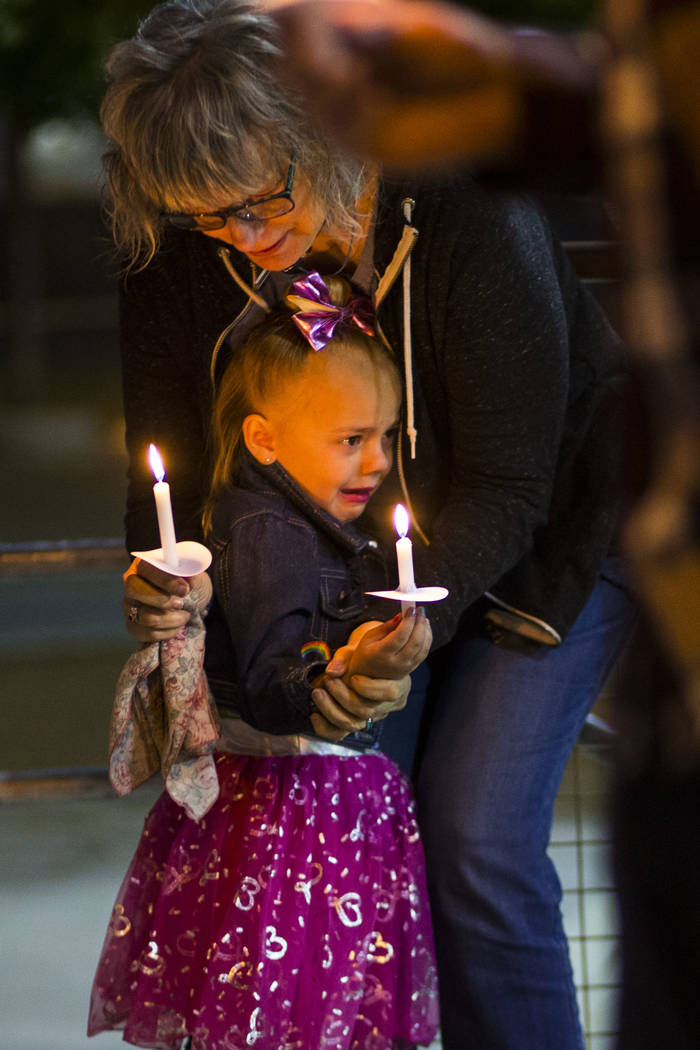 Kathleen Wheeler, above, comforts a young family member while remembering grandson, 6-year-old ...