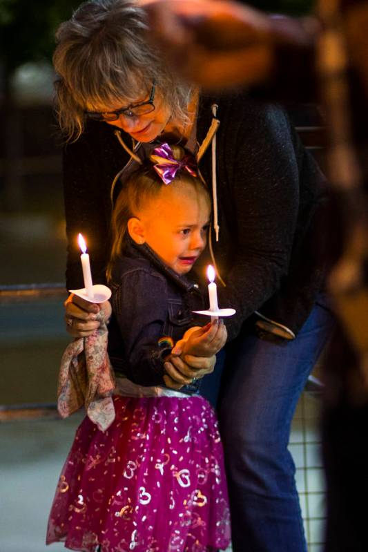 Kathleen Wheeler, above, comforts a young family member while remembering grandson, 6-year-old ...