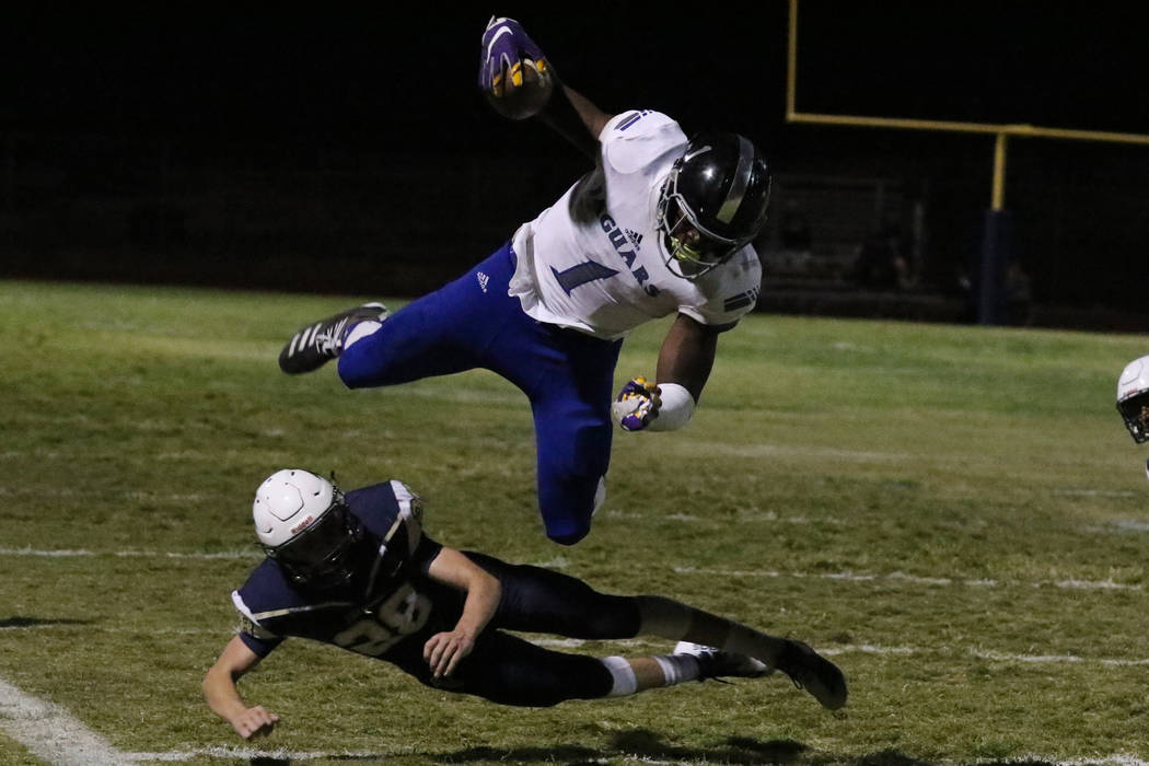 Desert Pines High's wide receiver Darnell Washington (1) avoids a tackle from Foothill High's&# ...