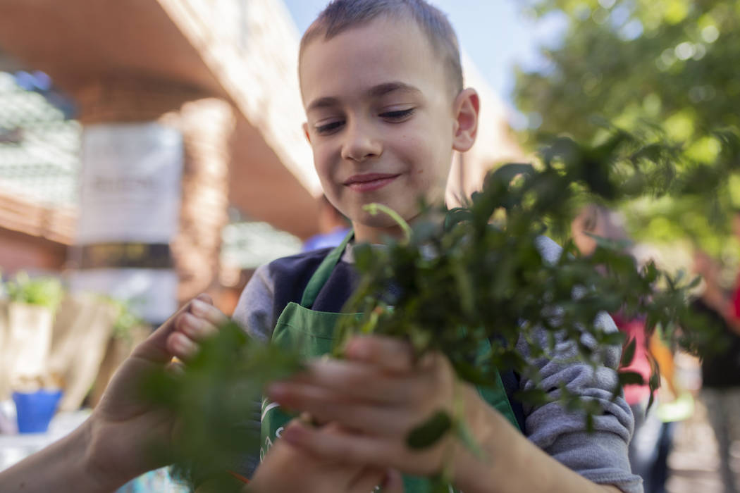 John C. Bass Elementary student Micah Mitchell, 6, holds fresh mint to sell during the nation's ...