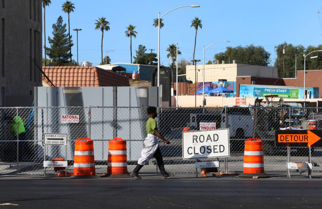 A client walks past road closure sign outside the Courtyard Homeless Resource Center on Wednesd ...