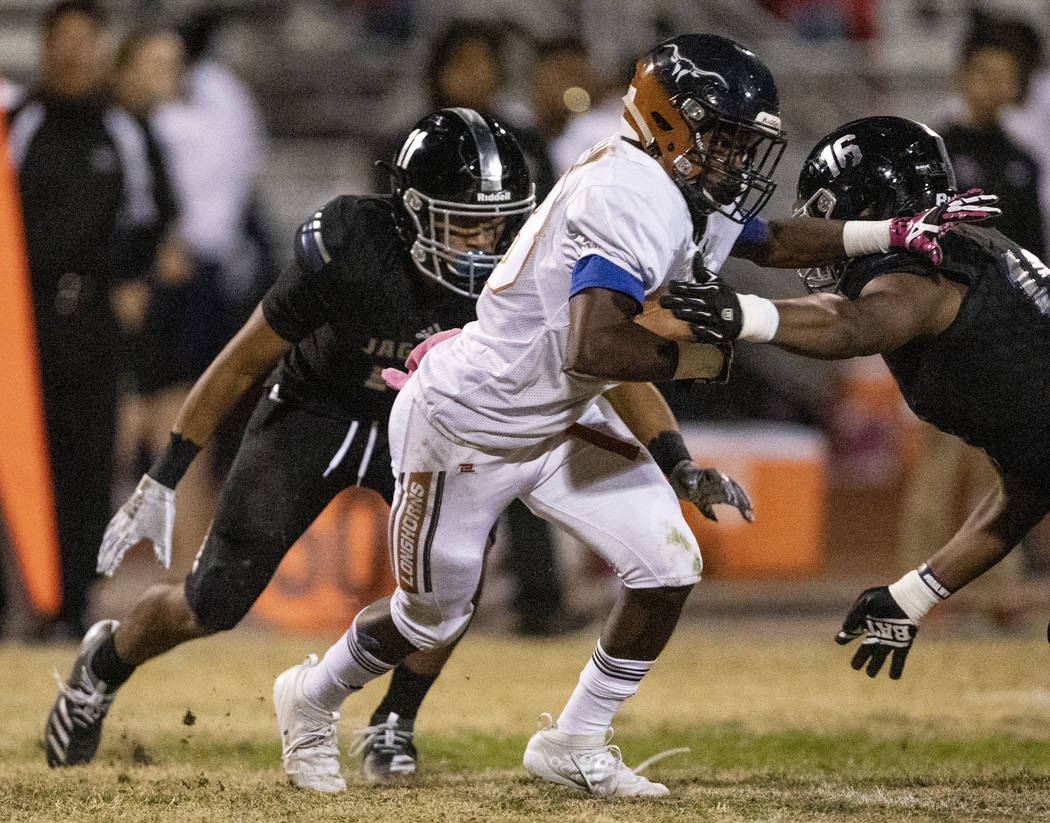 Legacy senior Carlos Julian rushes against the Desert Pines defense on Thursday, Oct. 24, 2019, ...
