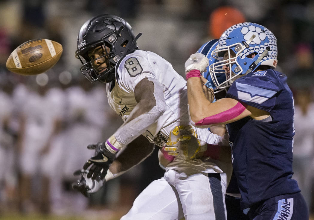 Palo Verde junior Adrian Ellis (8) is stripped of the ball by Centennial senior Nate Conger (9) ...