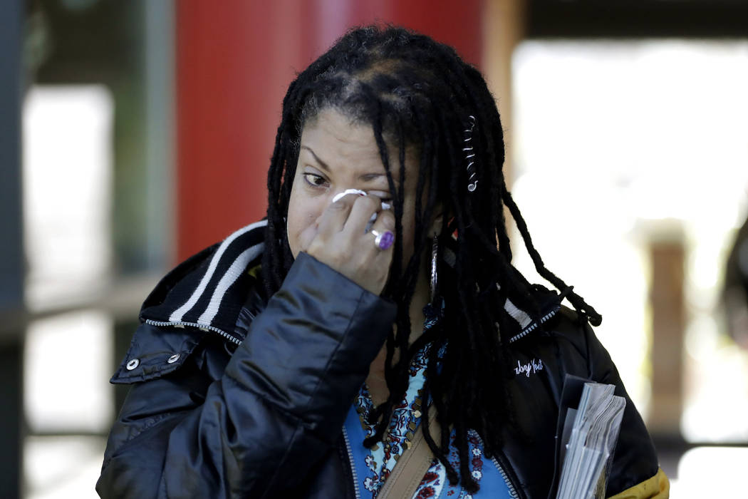 Katrina Hutton wipes tears as she leaves Gilliam Concert Hall after viewing the open casket of ...