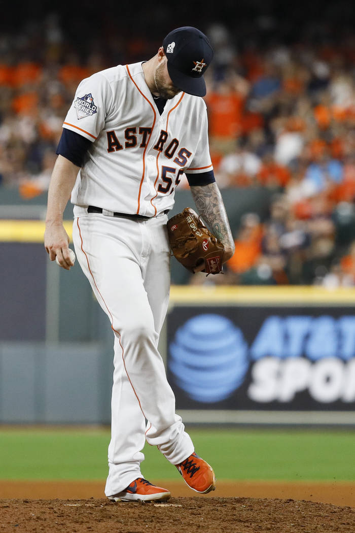 Houston Astros relief pitcher Ryan Pressly kicks the mound after giving up  a two-RBI single to …