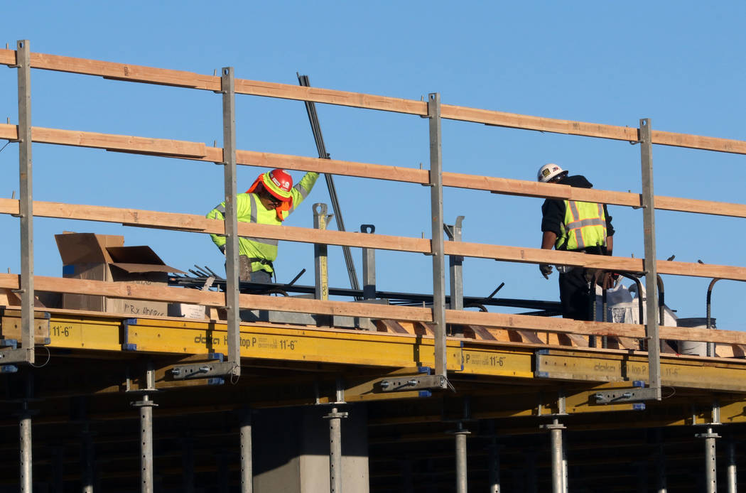Construction workers at the site of an apartment complex at the southwest corner of Casino Cent ...