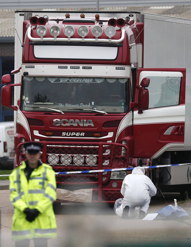 Police forensic officers attend the scene after a truck was found to contain a large number of ...