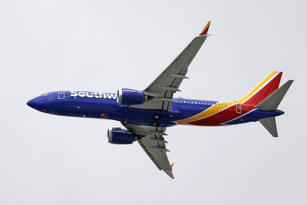 In a Wednesday, March 13, 2019, file photo, a Southwest Airlines Boeing 737 Max 8 jet flies ove ...