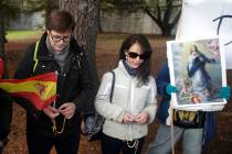 People pray the rosary outside the Fallen mausoleum near El Escorial, outskirts of Madrid, Thur ...