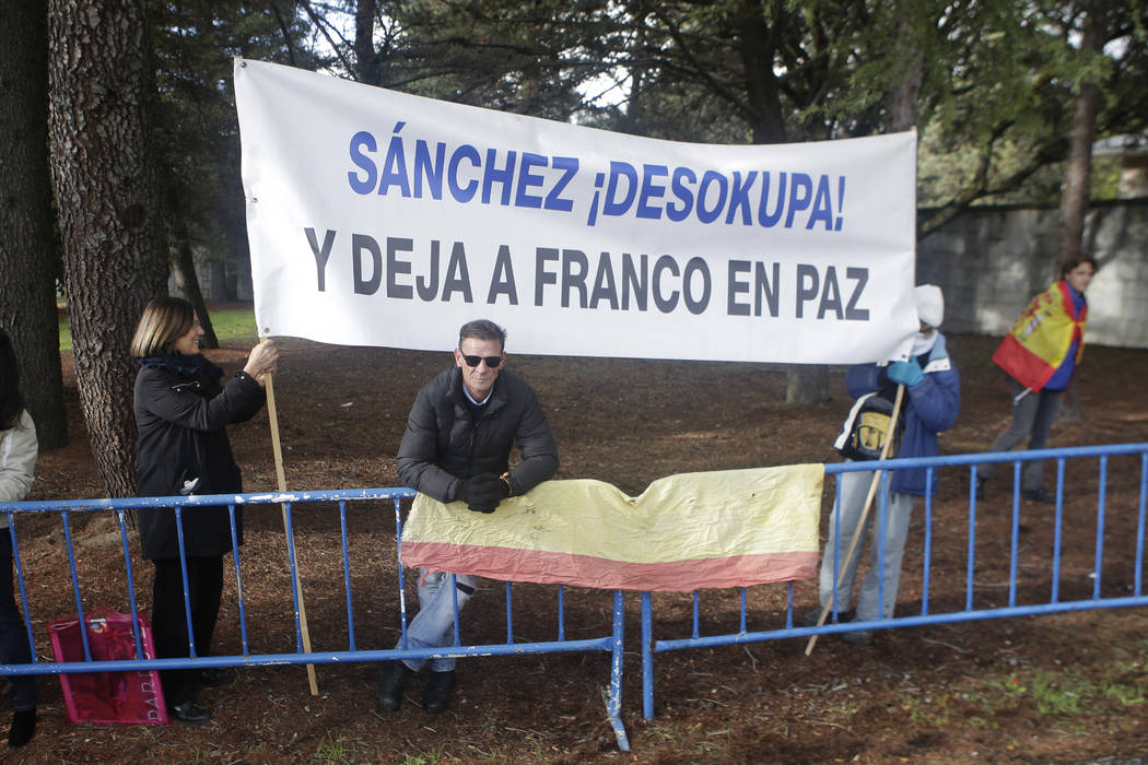 People carrying a banner reading in Spanish "Sanchez unworried. Leave Franco in Peace&quot ...