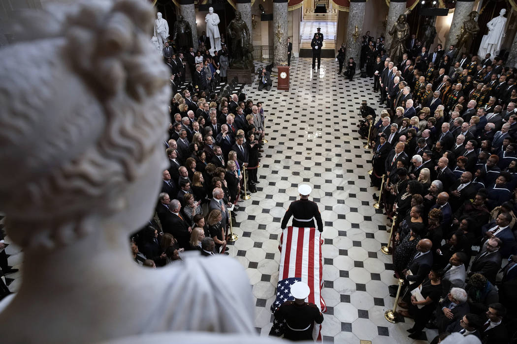 A military honor guard moves the casket Rep. Elijah Cummings, D-Md., into Statuary Hall at the ...