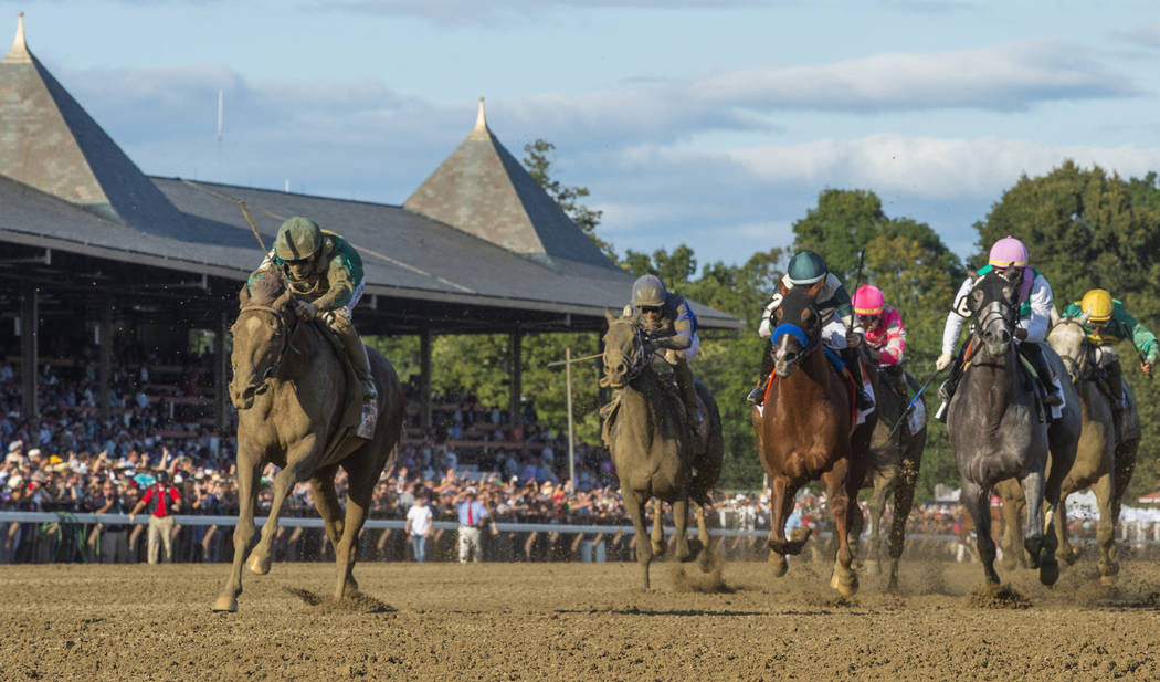 FILE- In this Aug. 24, 2019, file photo, Code of Honor, left, with jockey John Velazquez, leads ...