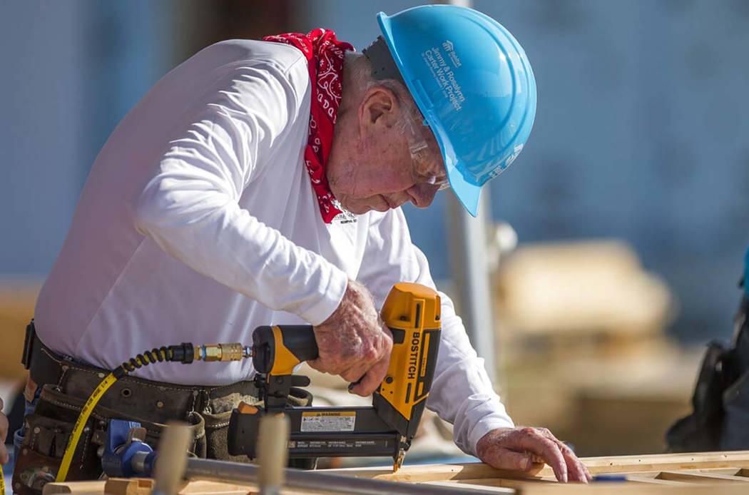 In an Aug. 27, 2018, file photo, former President Jimmy Carter works with other volunteers on s ...