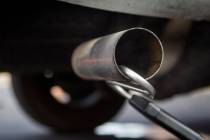 A probe is inserted in an exhaust pipe during a smog emissions test conducted at Nevada Departm ...