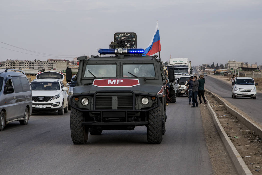 Russian forces patrol near the city of Qamishli, north Syria, Thursday, Oct. 24, 2019. Syrian f ...