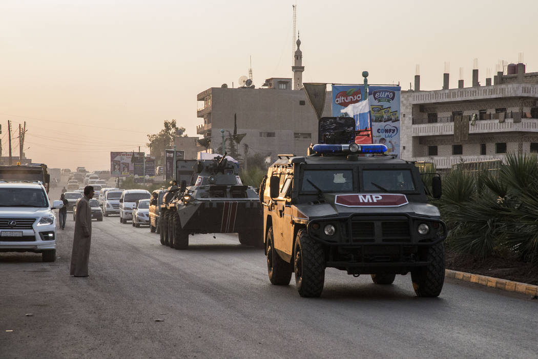 Russian forces patrol in the city of Amuda, north Syria, Thursday, Oct. 24, 2019. Syrian forces ...